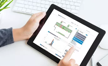 Hands holding tablet showing iOT smart water management interface