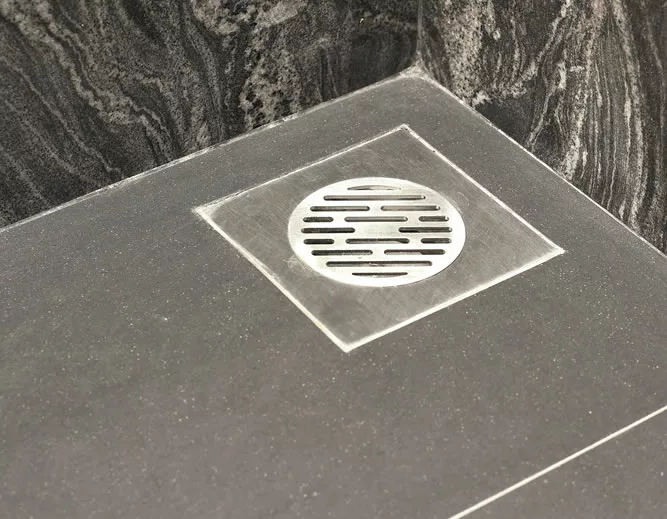 Floor drain on grey tiles