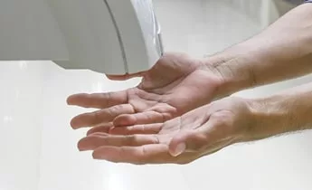 Hands under hand dryer