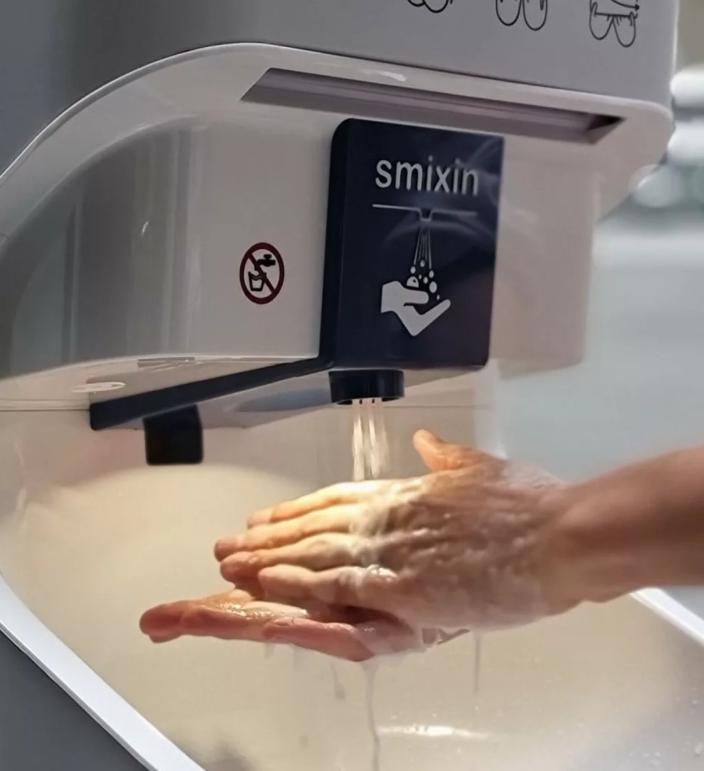 Close up of male hands washing with Smixin handwashing machine