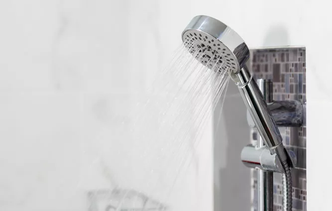 Showerhead on white tiles